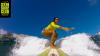 Surfeuse sur la vague Windy Reef du spot kitesurf et windsurf de Saint Martin aux Antilles