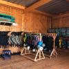 Intérieur du centre de kite en bois à La Tour d'Eole à Dakha avec des voiles Duotone de différentes tailles, des planches strapless et surf, et de l'équipements (gilets, casques, combinaisons) pour les cours